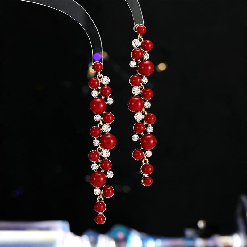 2025 Chinese retro red New Year's earrings, long temperament showing face, thin studs, exaggerated simple and versatile pearl earrings.