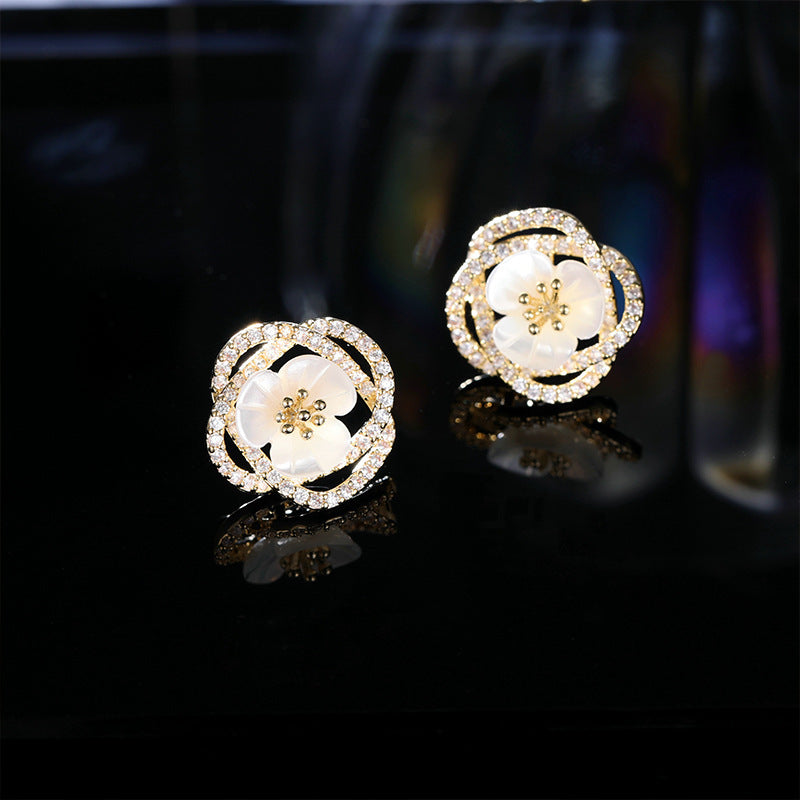 2025 Stylish hollow camellia simple temperament natural shell flower earrings s925 silver needle niche design earrings